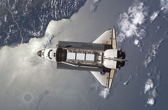 Shuttle Atlantis approaches the International Space Station 10-2002