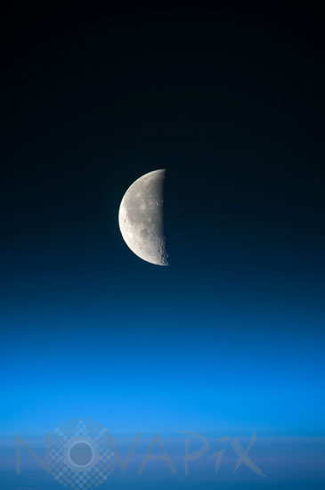 Half moon above Earth's atmosphere