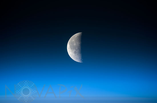 Half moon above Earth's atmosphere