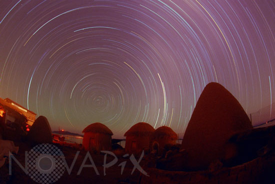 Circumpolar star trails above native Bolivian huts