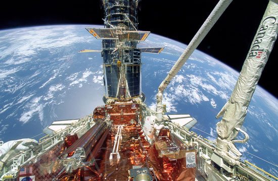 S.Musgrave during deployment of solar array panels on HST